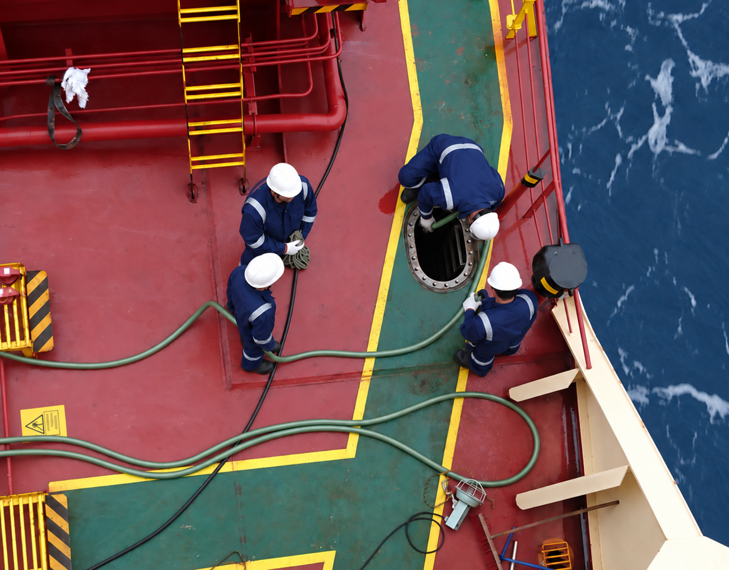 Tanker crew conducting cargo tank entry and hose connection on deck